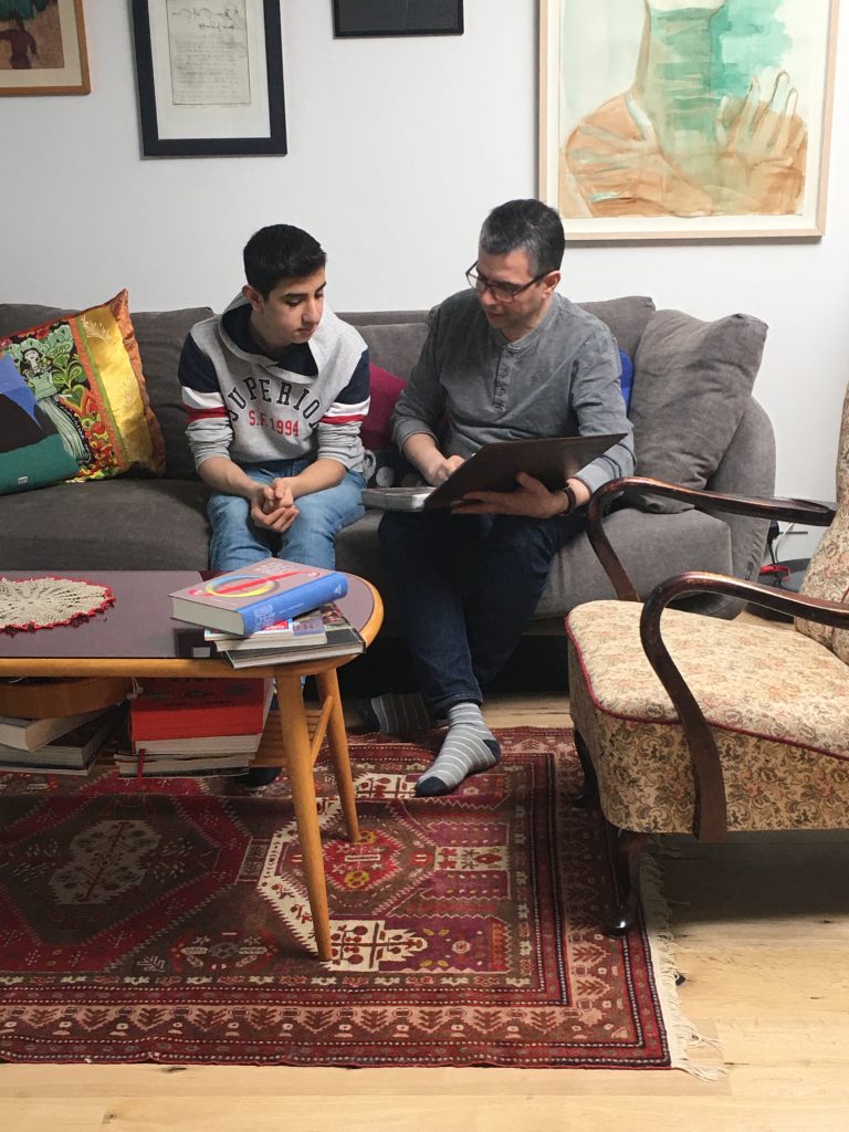 Nemandi og kennari sitja saman í sófa.